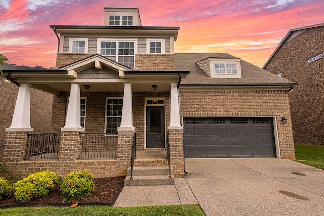 view of front of property with covered porch and a garage