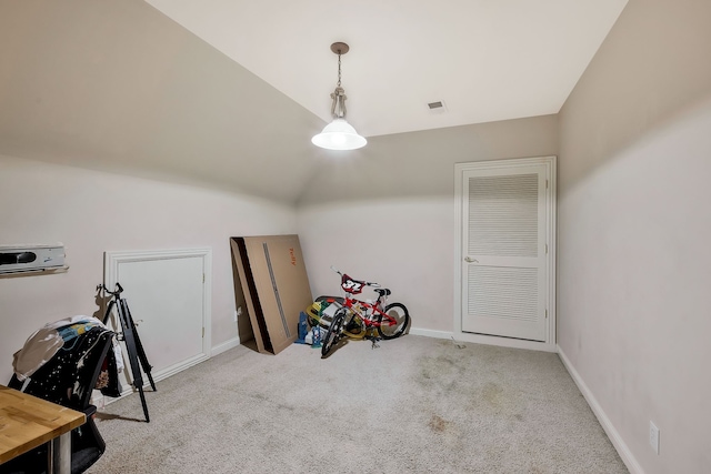 interior space featuring lofted ceiling and light carpet