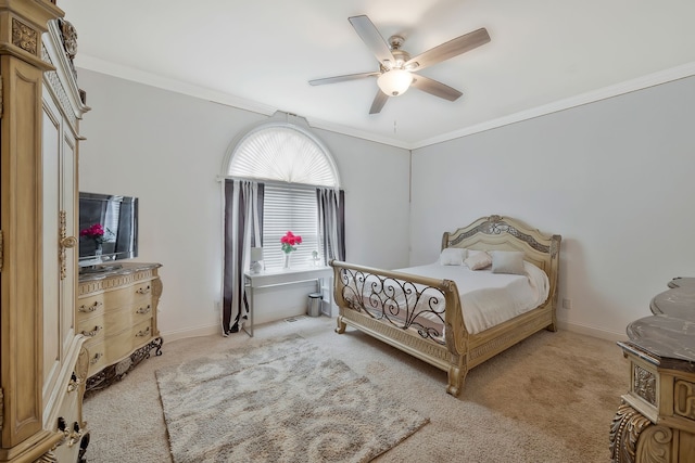 carpeted bedroom featuring ornamental molding and ceiling fan