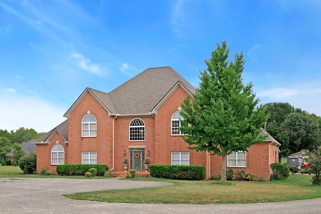 colonial-style house with a front yard