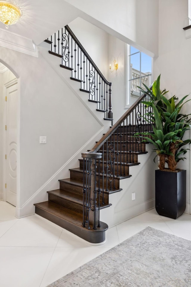 1077 Stockett Dr, Nashville, TN 37221 - stairway with tile patterned floors, arched walkways, and ornamental molding