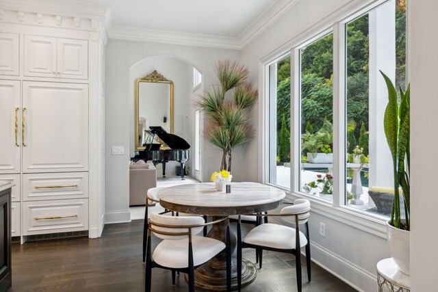 dining space featuring ornamental molding and dark hardwood / wood-style floors