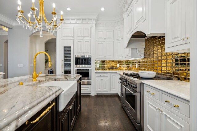 kitchen featuring hanging light fixtures, high end stainless steel range oven, a chandelier, dark hardwood / wood-style floors, and ornamental molding