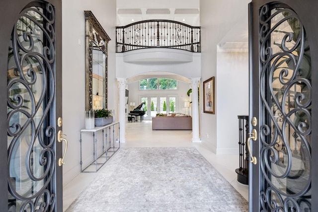 1077 Stockett Dr, Nashville, TN 37221 - entrance foyer with decorative columns, a towering ceiling, arched walkways, and baseboards