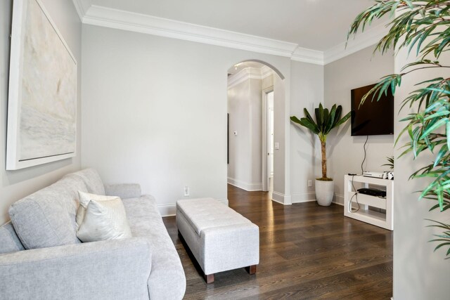 living room with crown molding and dark hardwood / wood-style flooring