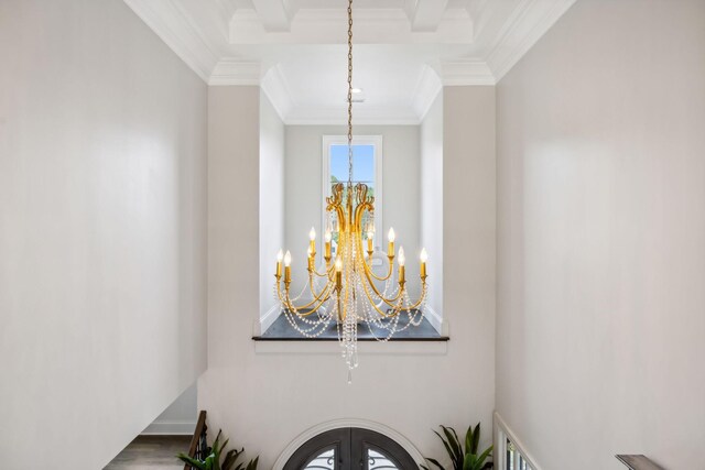 room details with crown molding, french doors, and a notable chandelier