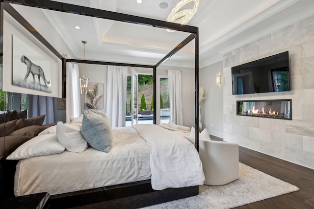 1077 Stockett Dr, Nashville, TN 37221 - bedroom with a tiled fireplace, a raised ceiling, wood finished floors, ornamental molding, and recessed lighting