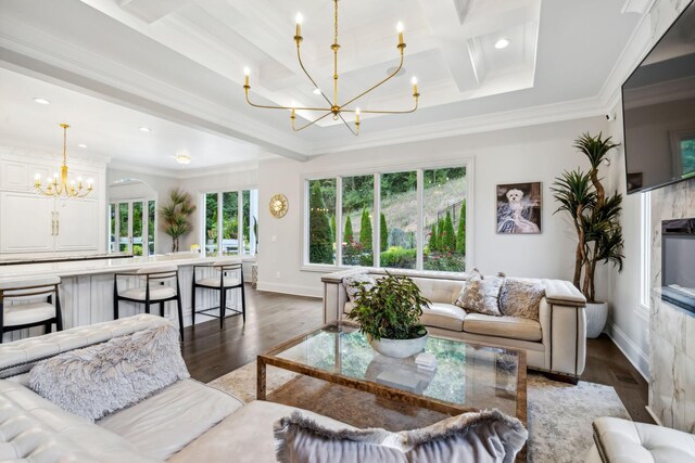 living room with hardwood / wood-style flooring, beam ceiling, a notable chandelier, and ornamental molding