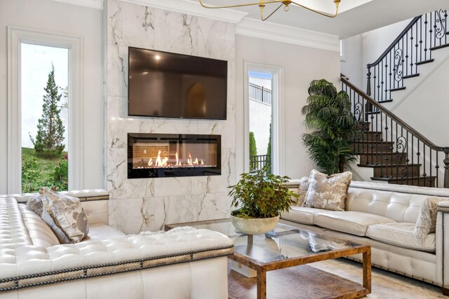 living room featuring a premium fireplace and ornamental molding