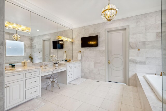 bathroom featuring vanity, tile walls, tile patterned flooring, and tiled bath