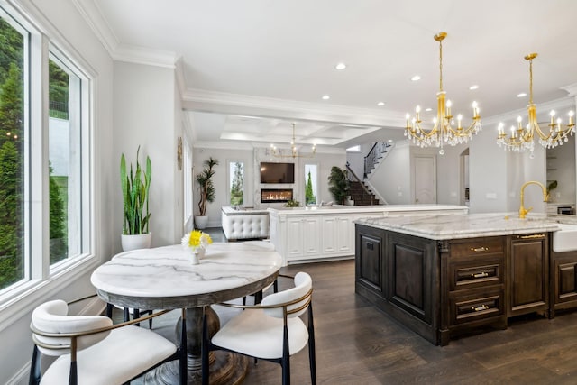 1077 Stockett Dr, Nashville, TN 37221 - kitchen with dark wood-style floors, a notable chandelier, a spacious island, and ornamental molding