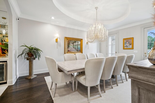 dining room featuring dark wood-type flooring, beverage cooler, a notable chandelier, and ornamental molding