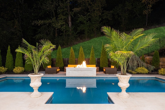 view of pool featuring a patio and an outdoor fire pit