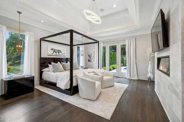 bedroom with a fireplace, dark hardwood / wood-style flooring, access to outside, and ornamental molding