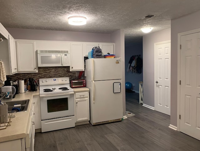 kitchen with dark wood-type flooring, white appliances, and white cabinets