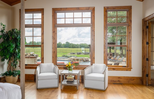 sitting room featuring vaulted ceiling and light wood-type flooring