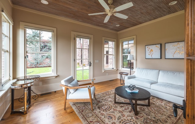 living room with light hardwood / wood-style flooring, ceiling fan, wood ceiling, and a healthy amount of sunlight