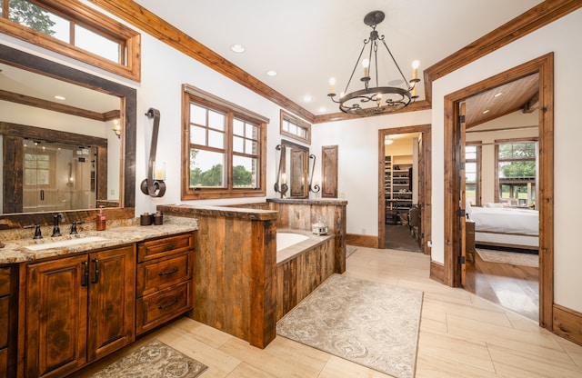 bathroom featuring hardwood / wood-style floors, a chandelier, crown molding, and vanity