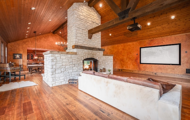 unfurnished living room featuring light wood-type flooring, a fireplace, beamed ceiling, a chandelier, and wood ceiling