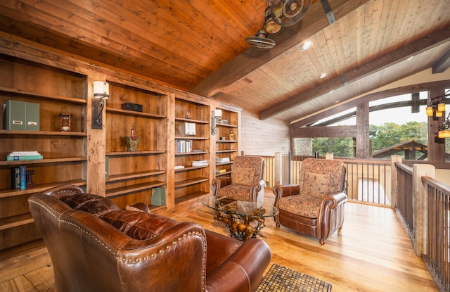 interior space featuring wooden ceiling, lofted ceiling with beams, built in shelves, and light hardwood / wood-style floors