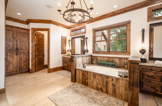 bathroom with crown molding, a chandelier, tiled bath, and vanity