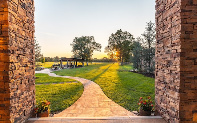 yard at dusk with a gazebo