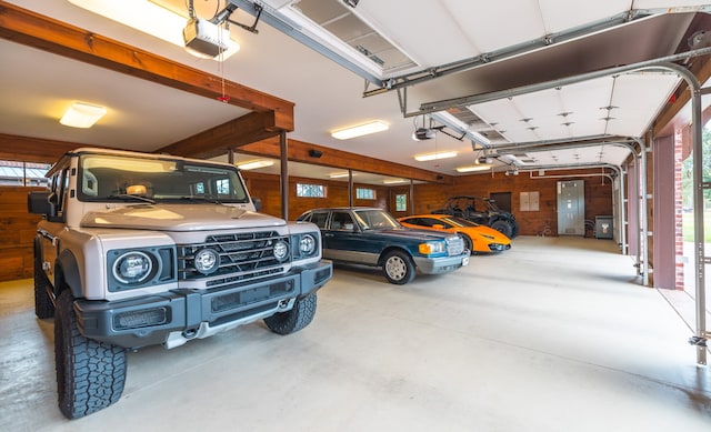 garage featuring wood walls and a garage door opener