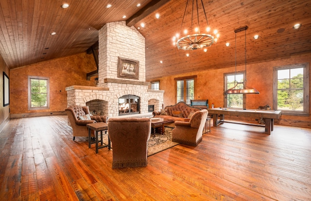 living room with high vaulted ceiling, a stone fireplace, wood ceiling, hardwood / wood-style flooring, and beam ceiling