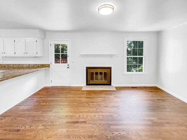 unfurnished living room featuring light wood-type flooring