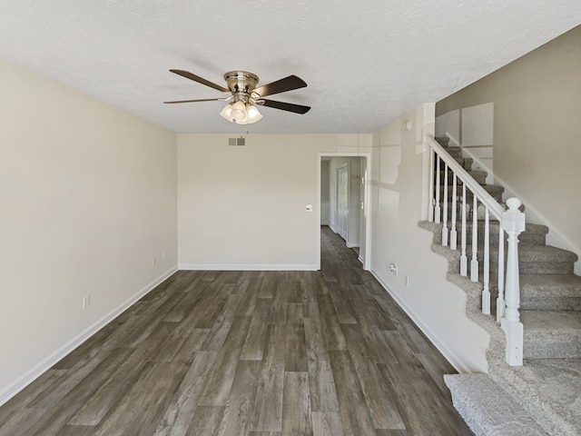 spare room featuring a textured ceiling, ceiling fan, and dark hardwood / wood-style floors