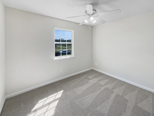 unfurnished room with ceiling fan and carpet flooring