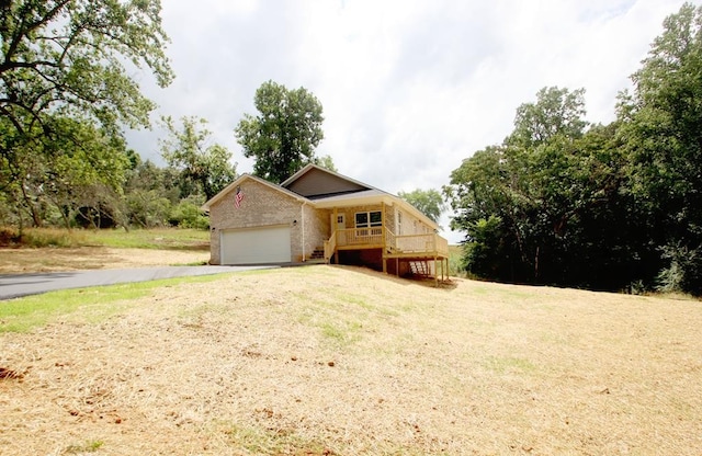 view of front facade with a front yard and a deck