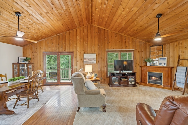 living room with a wealth of natural light, ceiling fan, and light hardwood / wood-style flooring