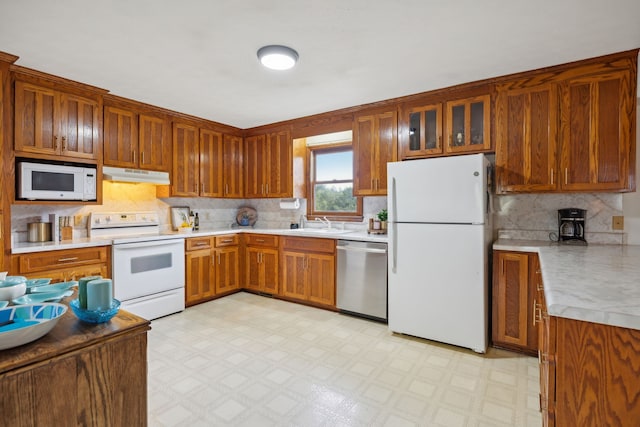 kitchen with white appliances and sink