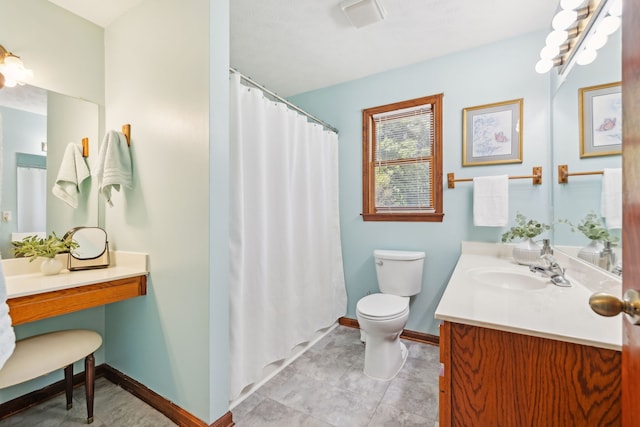 bathroom with curtained shower, vanity, toilet, and tile patterned floors