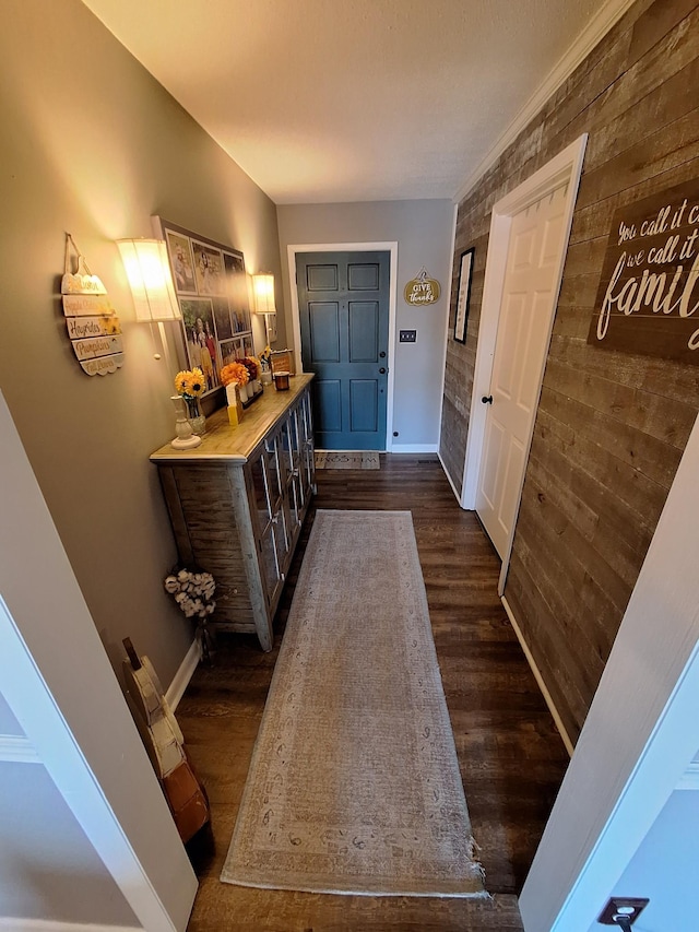 foyer with baseboards and dark wood finished floors