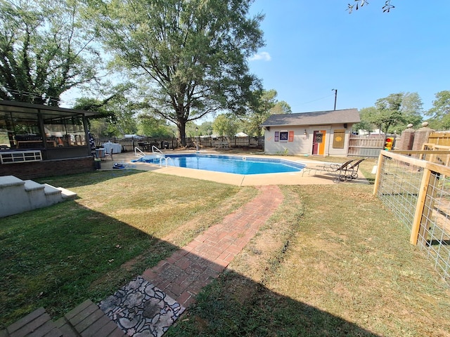 view of pool featuring an outbuilding, a patio, a fenced in pool, a fenced backyard, and a lawn