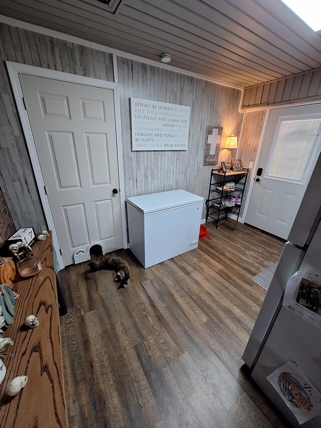 interior space featuring wooden ceiling, hardwood / wood-style flooring, and wooden walls