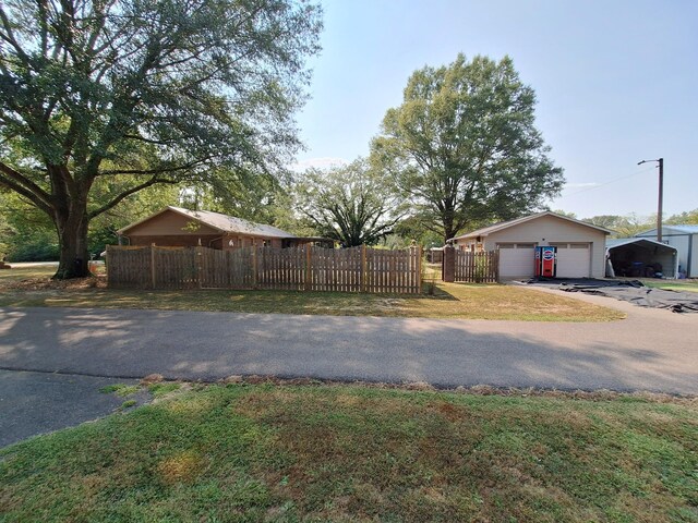 view of side of property featuring an outdoor structure, a lawn, and a garage