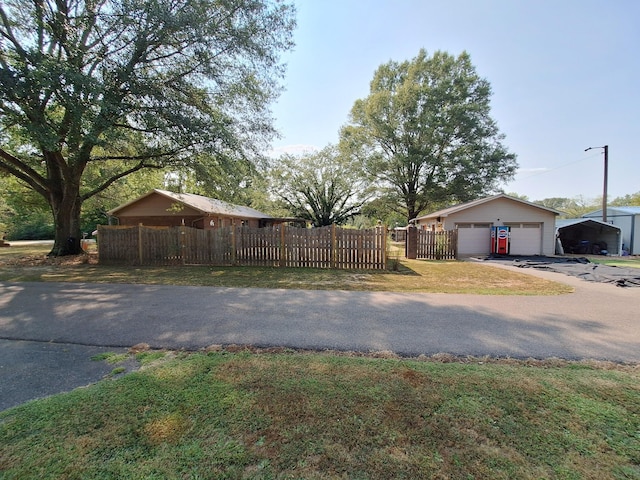 view of yard with a garage and a fenced front yard