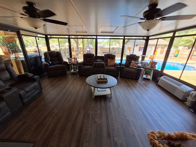 sunroom / solarium with ceiling fan and a wall mounted air conditioner