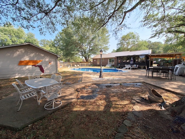 view of pool featuring outdoor dining space, a patio, a fenced in pool, and fence