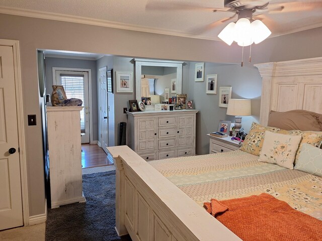 carpeted bedroom featuring ceiling fan and ornamental molding