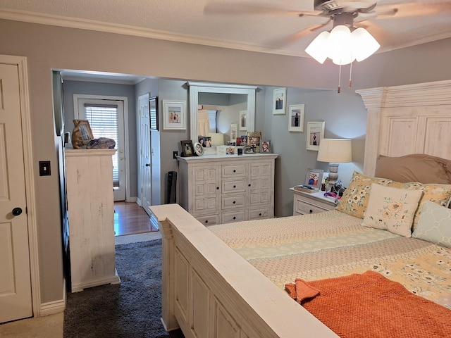 bedroom featuring dark carpet, ceiling fan, baseboards, and ornamental molding