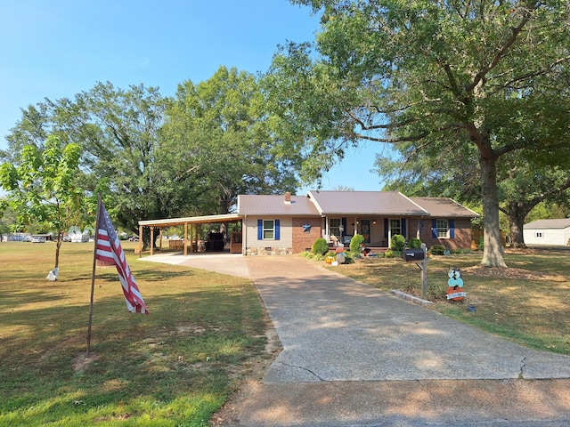 view of front of property featuring a front lawn, crawl space, metal roof, a carport, and driveway