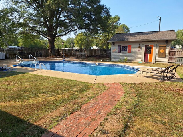 view of swimming pool with a lawn and a patio area