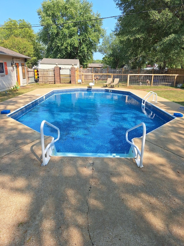 view of swimming pool featuring a fenced in pool, a fenced backyard, and a patio area