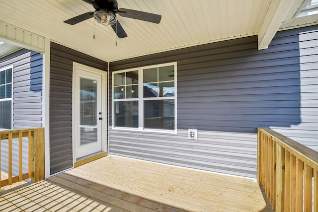 wooden deck featuring ceiling fan