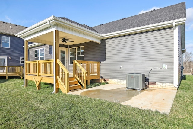 back of property with ceiling fan, central air condition unit, a patio area, a yard, and a wooden deck