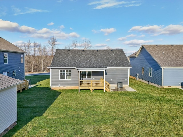 back of property with a wooden deck, cooling unit, and a yard